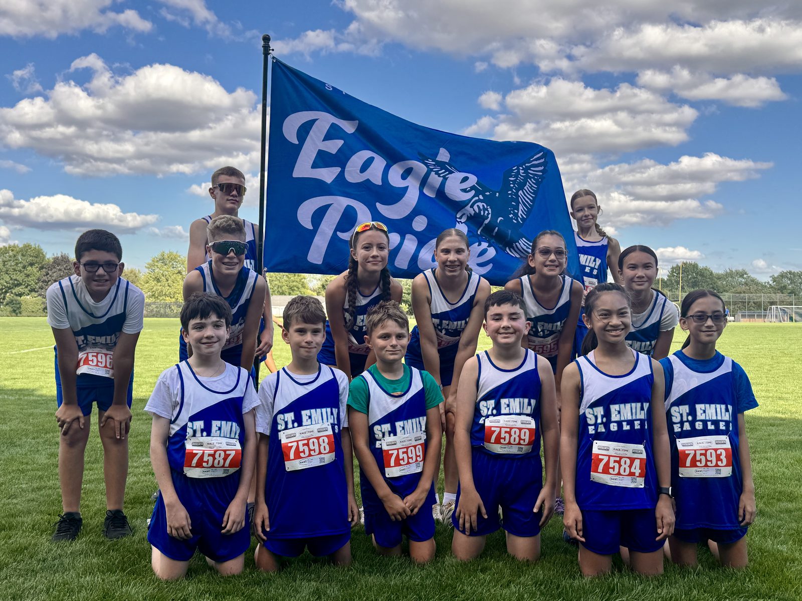 St. Emily Eagles cross country team with the Eagle Pride banner